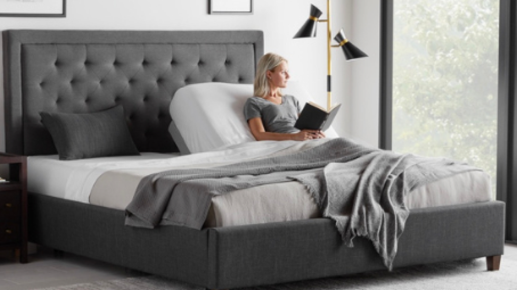 Woman using a Malouf adjustable base for reading comfort demonstrating versatility of these bases sold at Fosters Mattress in the Cedar Valley