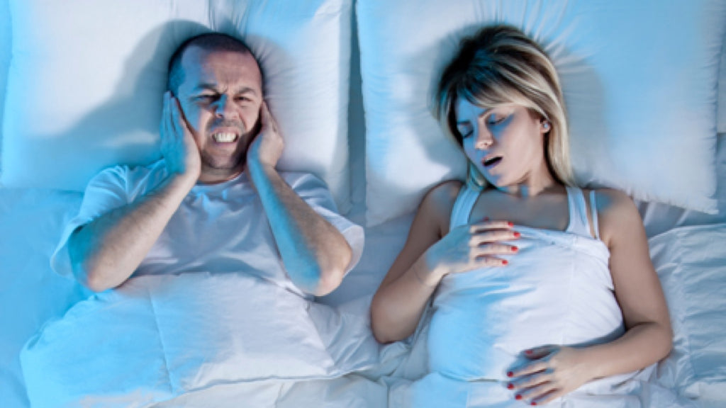 Image of woman snoring and man covering ears - Fosters Mattress Blog Post