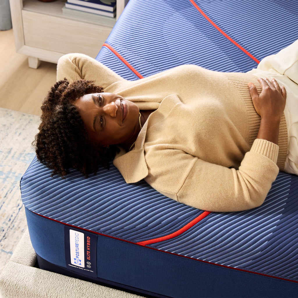 Sealy Posturepedic® Elite Hybrid Soft Mattress, Lifestyle View of Woman on bed