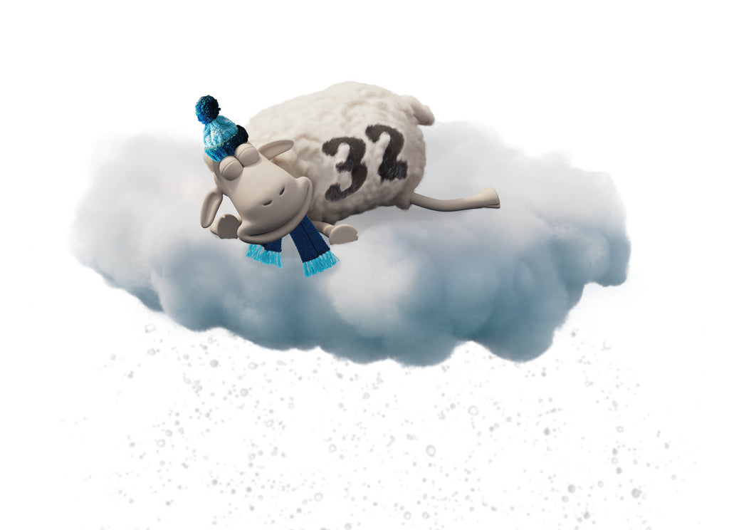 Serta sheep sleeping on a cloud.